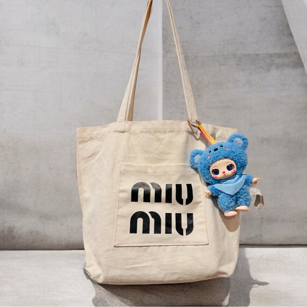Miu Miu Beige Canvas Tote with Black Logo and Blue Charm